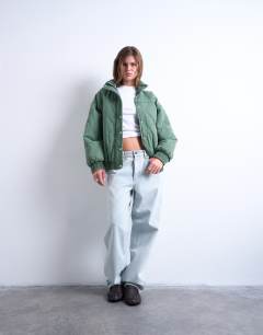 Model wearing Acid wash oversized quilted cotton bomber jacket in green