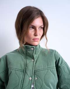 Model wearing Acid wash oversized quilted cotton bomber jacket in green