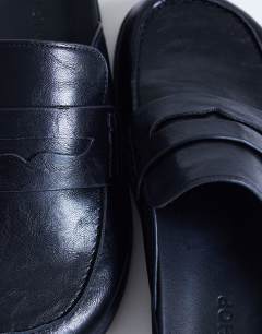 Model wearing Addie loafer mule in black