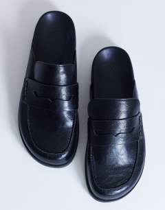 Model wearing Addie loafer mule in black