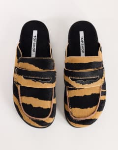 Model wearing Addie loafer mule in zebra print hair on real leather