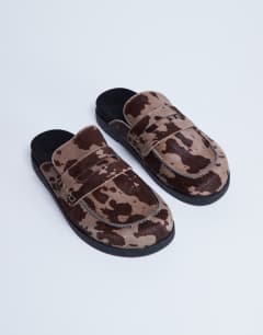 Model wearing Addie mule loafer in cow print hair on real leather
