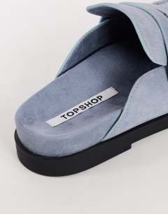 Model wearing Addie real suede mule loafer in cornflower blue
