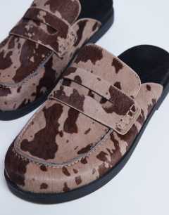 Model wearing Addie real suede mule loafer in cow pony