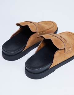Model wearing Addie real suede mule loafer in tan