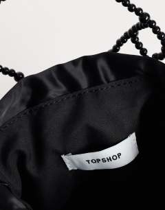 Model wearing Adele small diamond bead grab bag in black