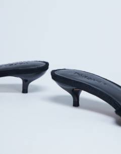 Model wearing Alba peep toe kitten heel mule in black hair on real leather