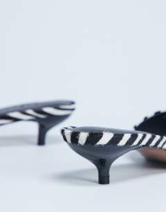 Model wearing Alba peep toe kitten heel mule in zebra print hair on real leather