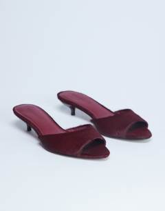 Model wearing Alba real leather peep toe kitten heel mule in red pony