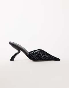 Model wearing Alessio angular heel pointed court shoe in black zebra mesh