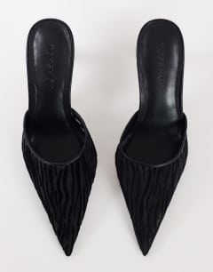 Model wearing Alessio angular heel pointed court shoe in black zebra mesh