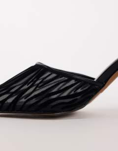 Model wearing Alessio angular heel pointed court shoe in black zebra mesh