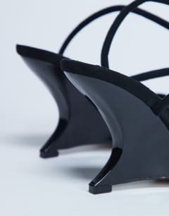 Model wearing Alexa sculptured wedge sandal in black