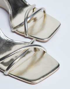 Model wearing Alexa sculptured wedge sandal in gold