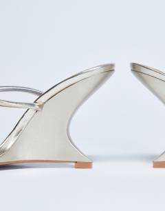 Model wearing Alexa sculptured wedge sandal in gold