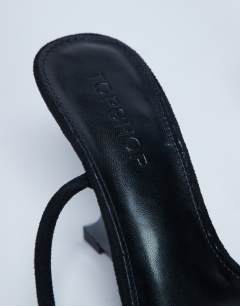 Model wearing Alexa wedge heeled mule in black