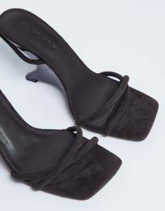 Model wearing Alexa wedge heeled mule in chocolate