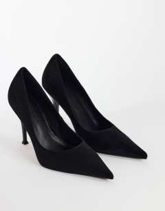 Model wearing Alexander high heel court shoe in black faux suede