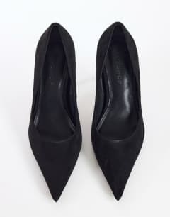 Model wearing Alexander high heel court shoe in black faux suede