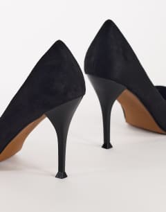 Model wearing Alexander high heel court shoe in black faux suede