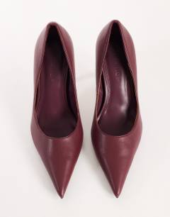 Model wearing Alexander high heel court shoe in burgundy