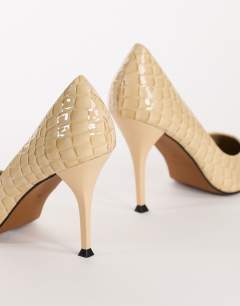 Model wearing Alexander high heel court shoe in off white croc
