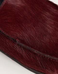 Model wearing Alexia long hair on real leather loafer mule in merlot