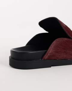 Model wearing Alexia long hair on real leather loafer mule in merlot