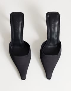 Model wearing Alfie pointed heeled court in black satin