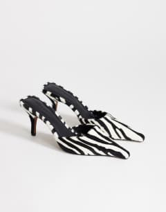 Model wearing Alfie pointed mid heeled court in zebra print hair on real leather