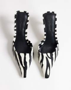Model wearing Alfie pointed mid heeled court in zebra print hair on real leather