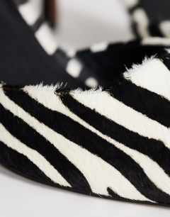 Model wearing Alfie pointed mid heeled court in zebra print hair on real leather
