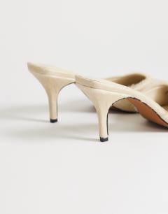Model wearing Alfie real hair on leather pointed mid heeled mule court shoe in off white