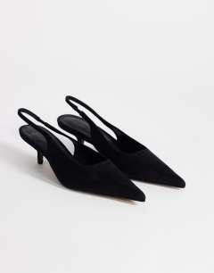 Model wearing Ali kitten heel sling back court in black faux suede