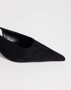 Model wearing Ali kitten heel sling back court in black faux suede