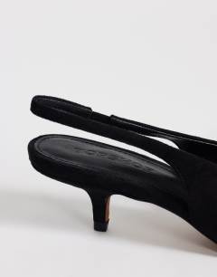 Model wearing Ali kitten heel sling back court in black faux suede