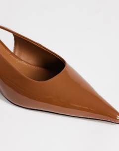 Model wearing Ali kitten heel sling back court in tan patent