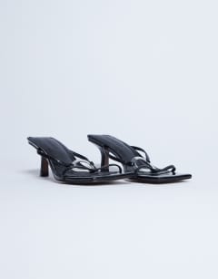 Model wearing Alice hardware square toe heeled mule in black