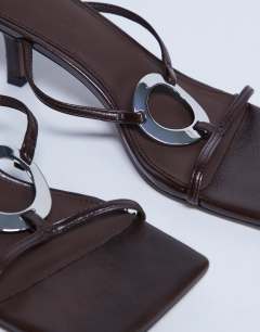 Model wearing Alice hardware square toe heeled mule in chocolate