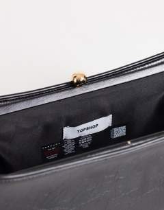 Model wearing Alice medium clutch bag in black