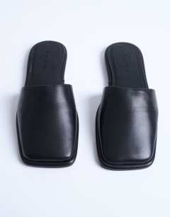 Model wearing Almina real leather square toe mules in black