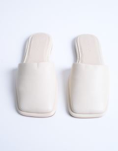 Model wearing Almina real leather square toe mules in off white