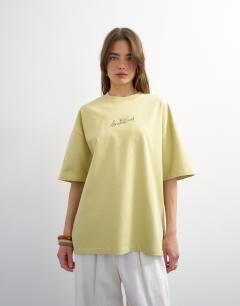 Model wearing Amalfi embroidered graphic oversized tee in lime green