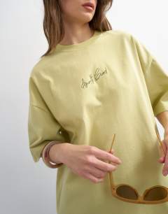 Model wearing Amalfi embroidered graphic oversized tee in lime green