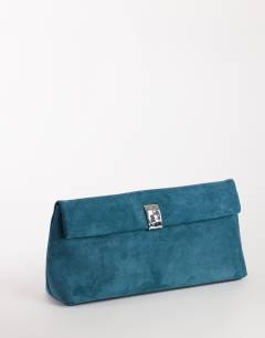 Model wearing Amber oversized suedette fold over clutch bag with hardware in teal