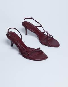 Model wearing Amelia minimal mid heel sandal in burgundy