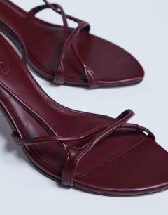 Model wearing Amelia minimal mid heel sandal in burgundy