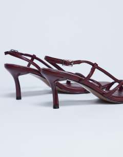Model wearing Amelia minimal mid heel sandal in burgundy