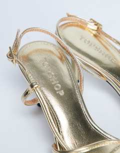 Model wearing Amelia minimal mid heel sandal in gold