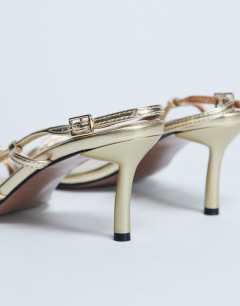 Model wearing Amelia minimal mid heel sandal in gold